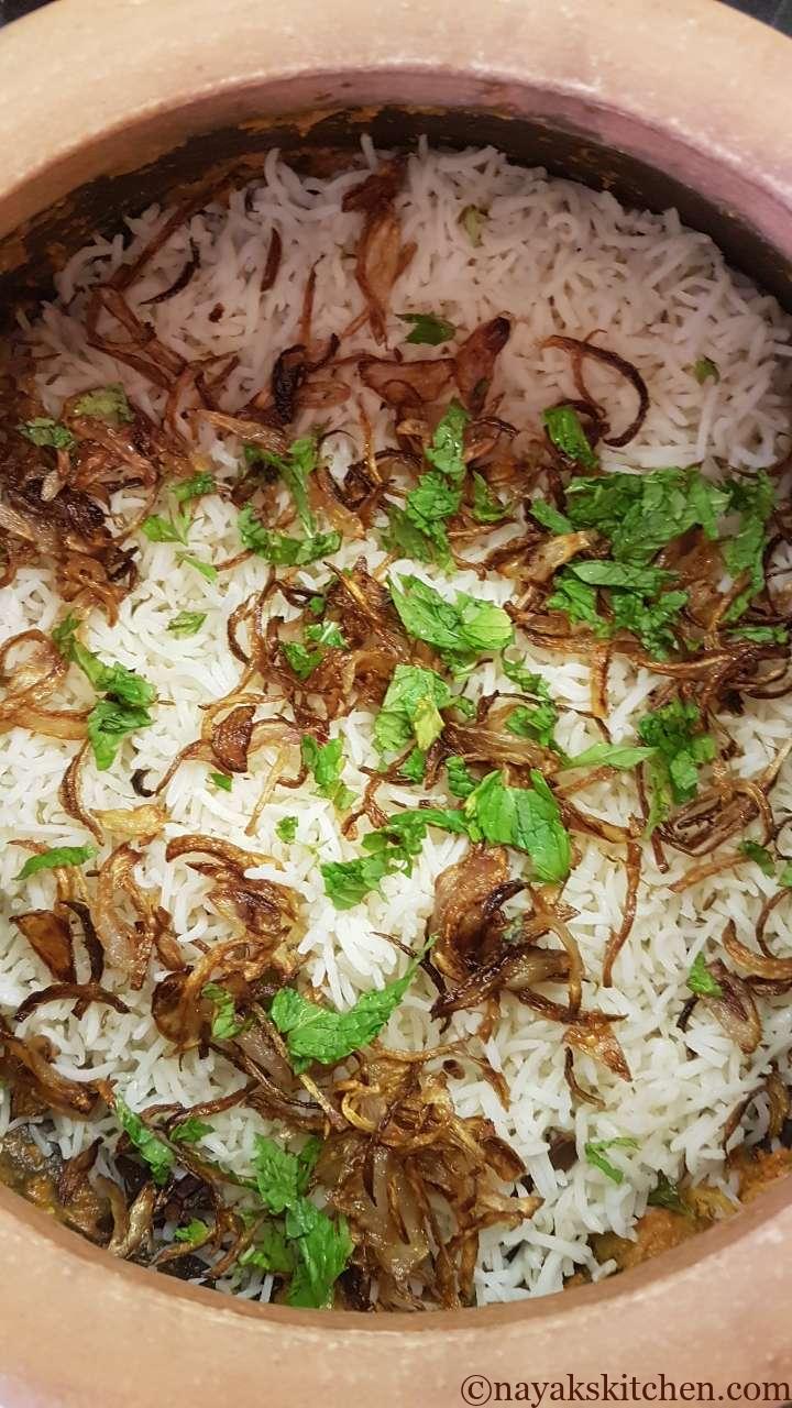 Adding fried onions and mint leaves
