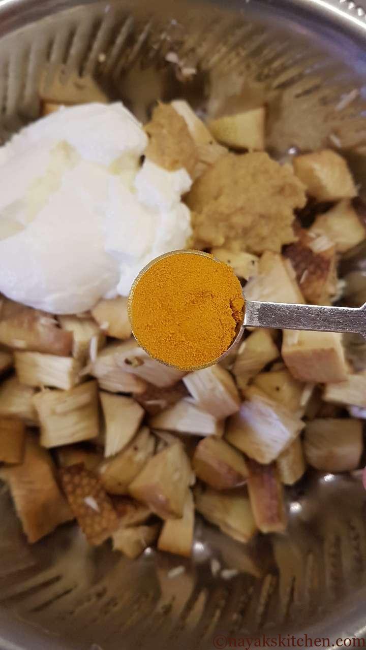 Adding turmeric powder to jackfruit pieces