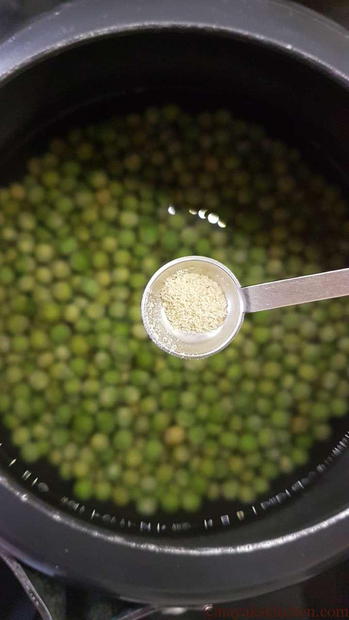 Adding hing while cooking green peas