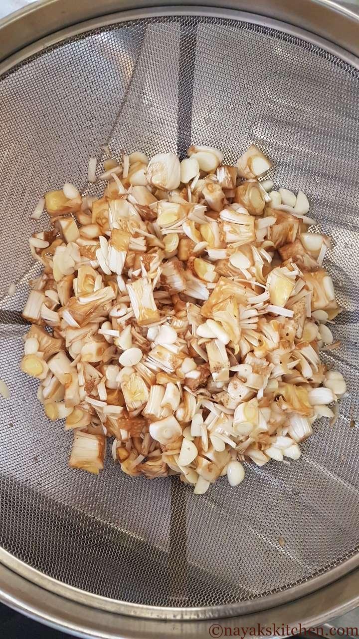 Draining the water from raw jackfruit