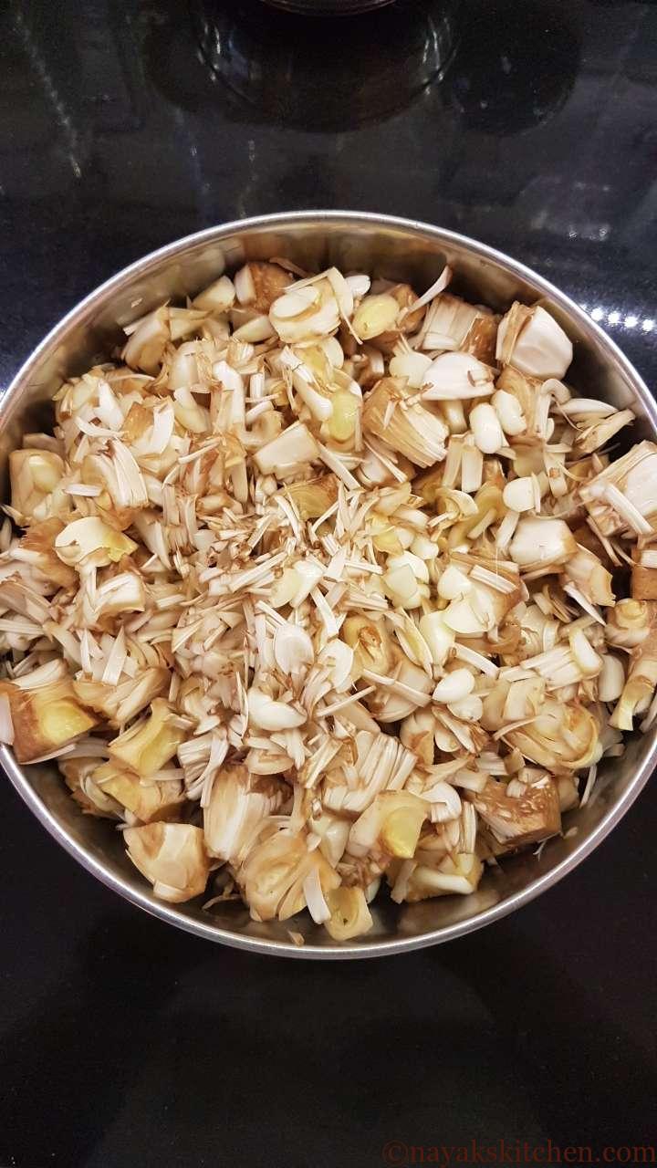 Adding raw jackfruit to a vessel