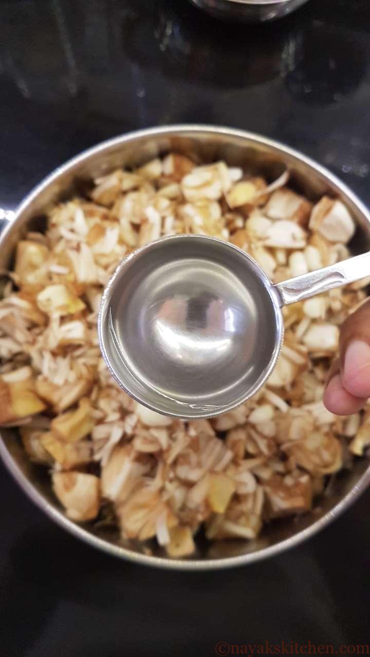 Adding water to cook the raw jackfruit