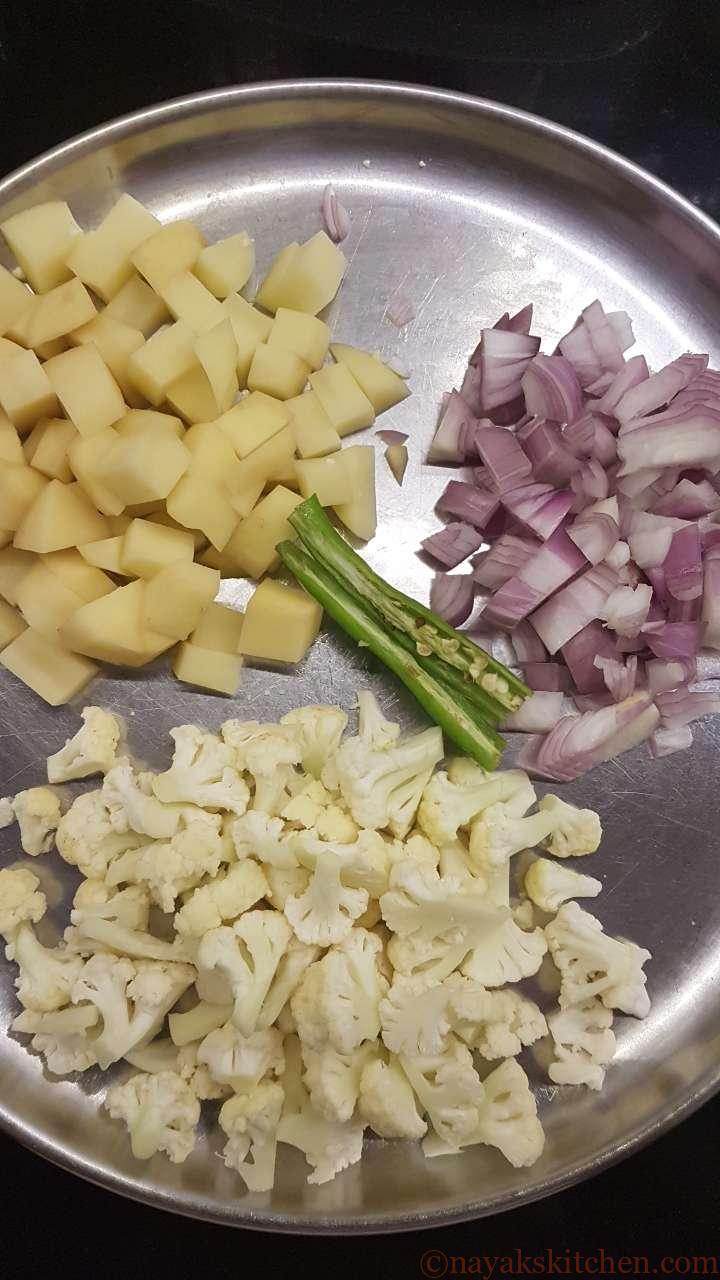 Chopped potato, cauliflower, onions and slit green chilli.