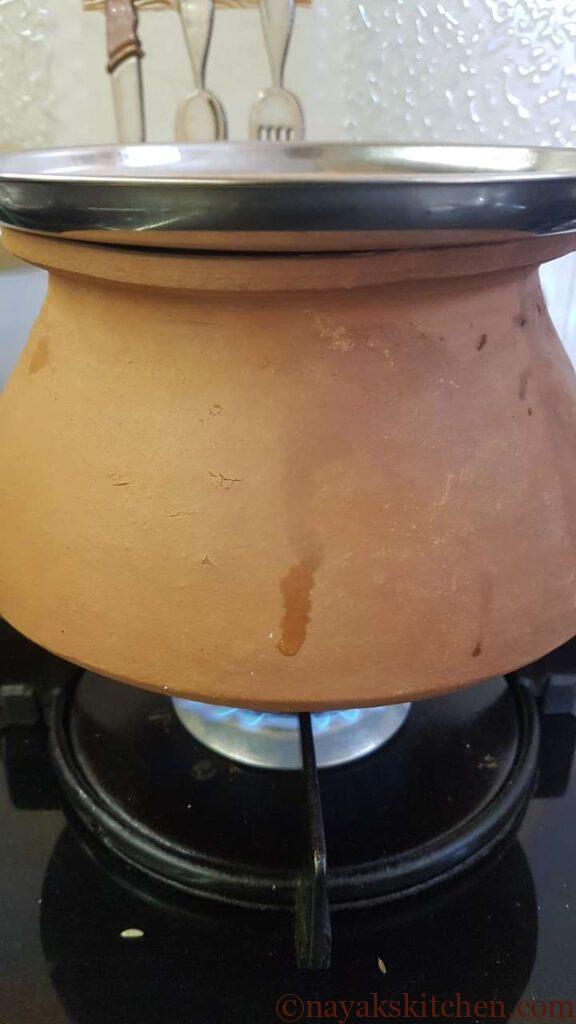 Cooking drumsticks and raw mango for goan prawns curry