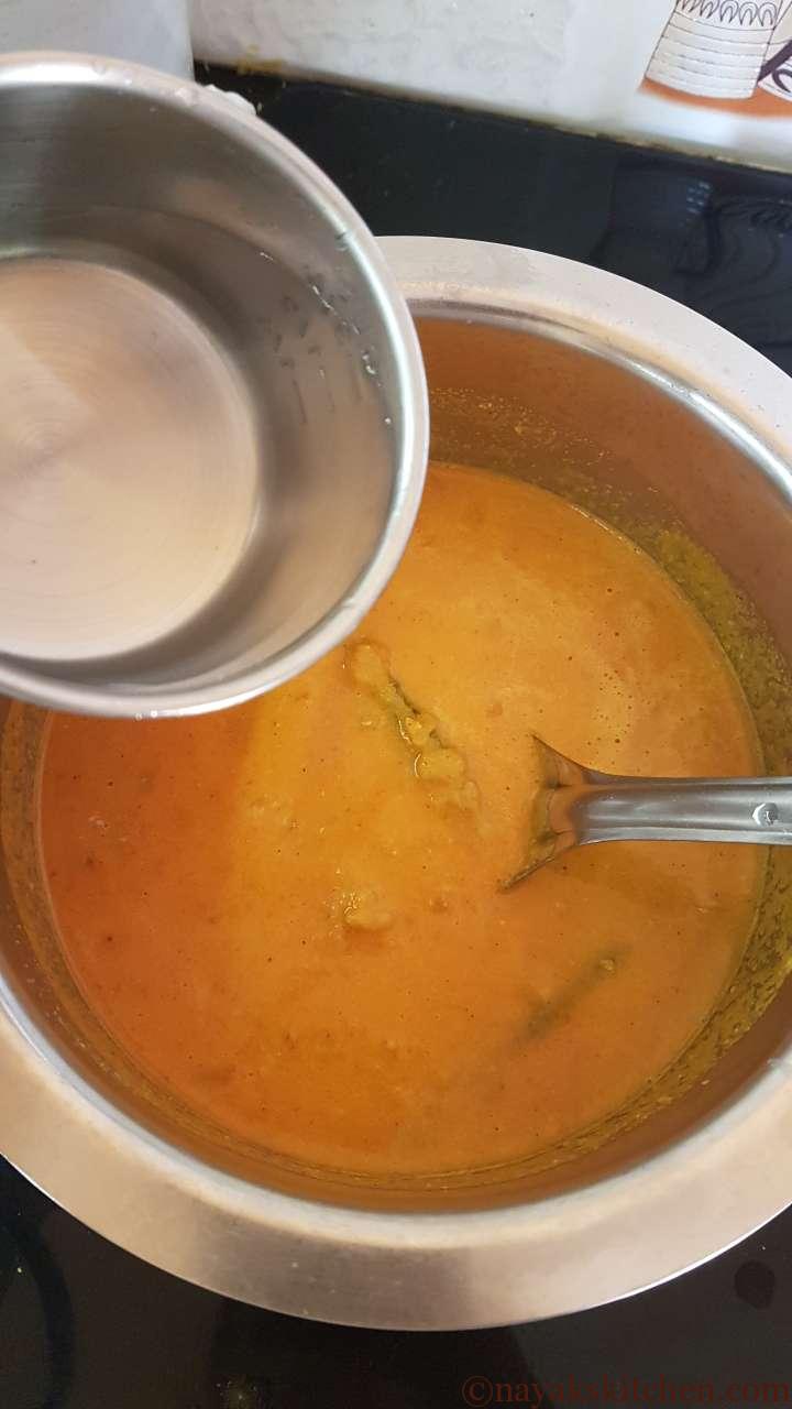 Adding water to drumsticks curry